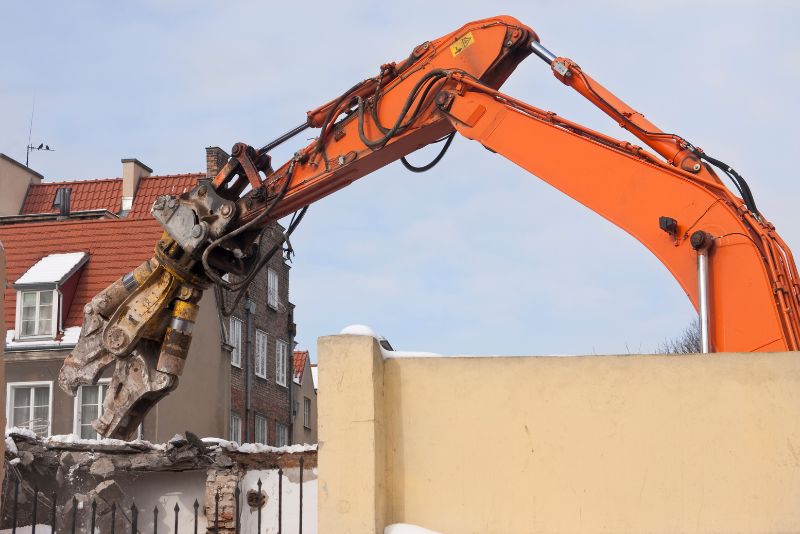 excavator demolishing a home