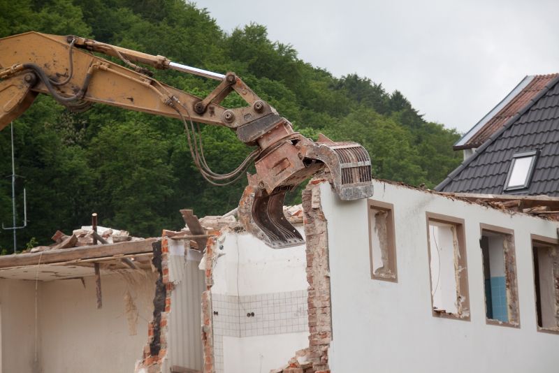 excavator demolishing a home